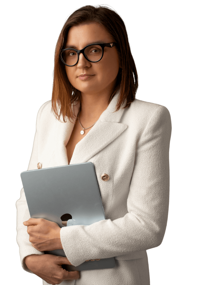 Katrina Kabacinska-Pietrzak, founder of AccountWell & Co., in a white blazer holding a laptop